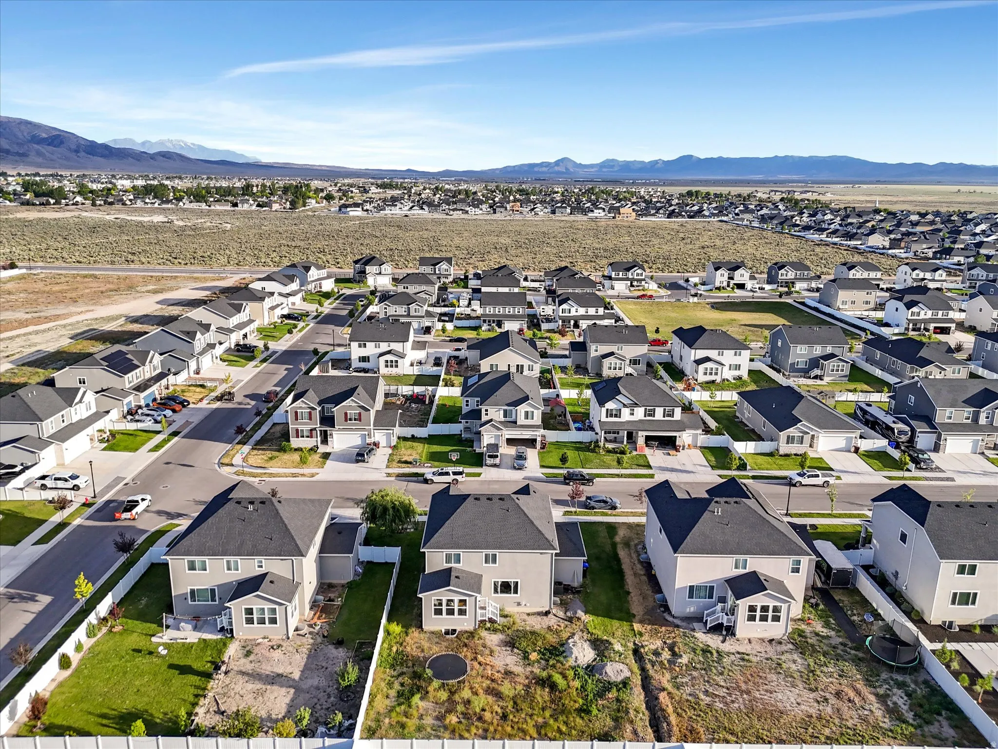 Aerial view of a residential neighborhood with distant mountain scenery