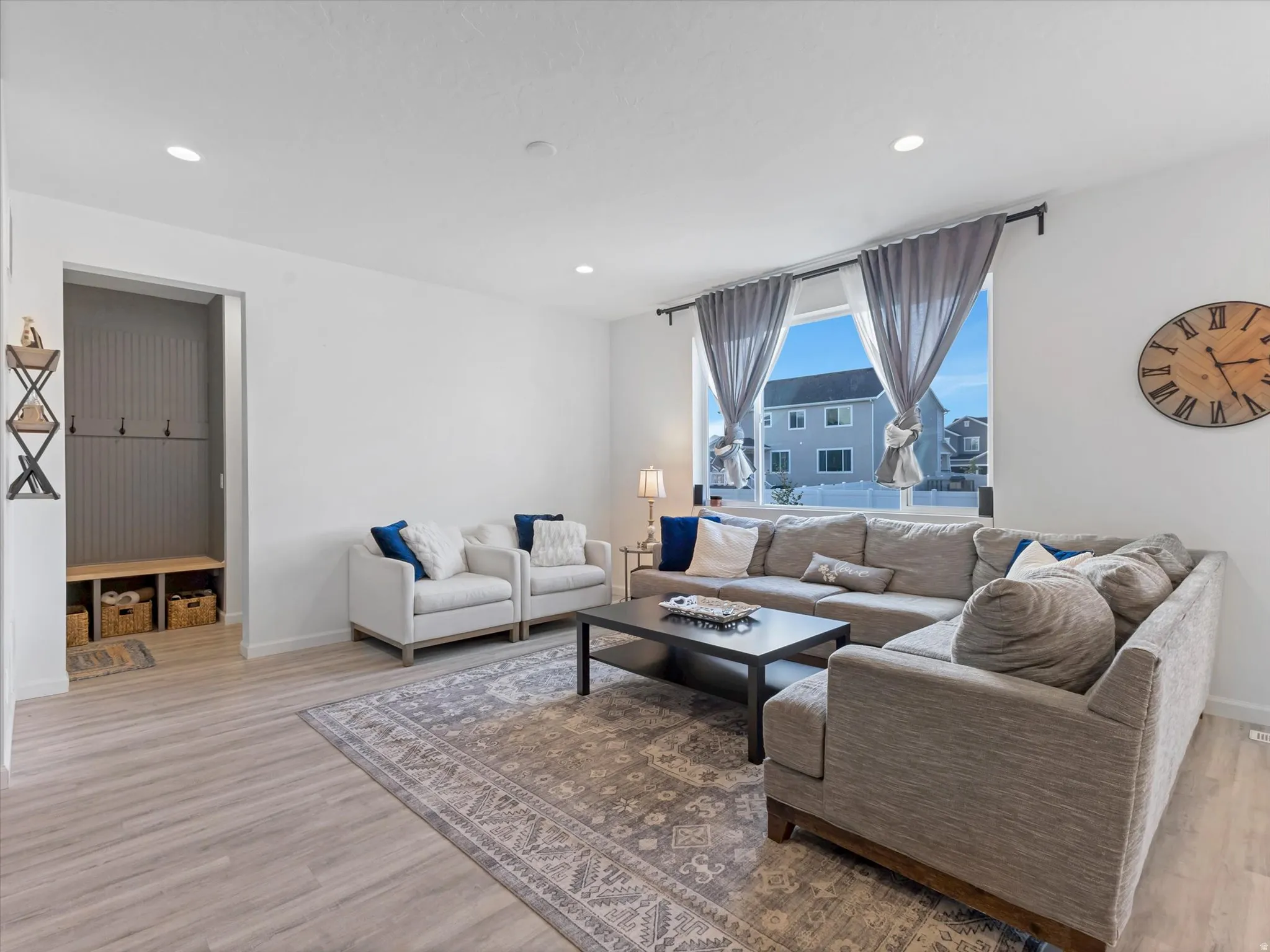 Bright living area featuring wood-finish flooring and recessed lighting