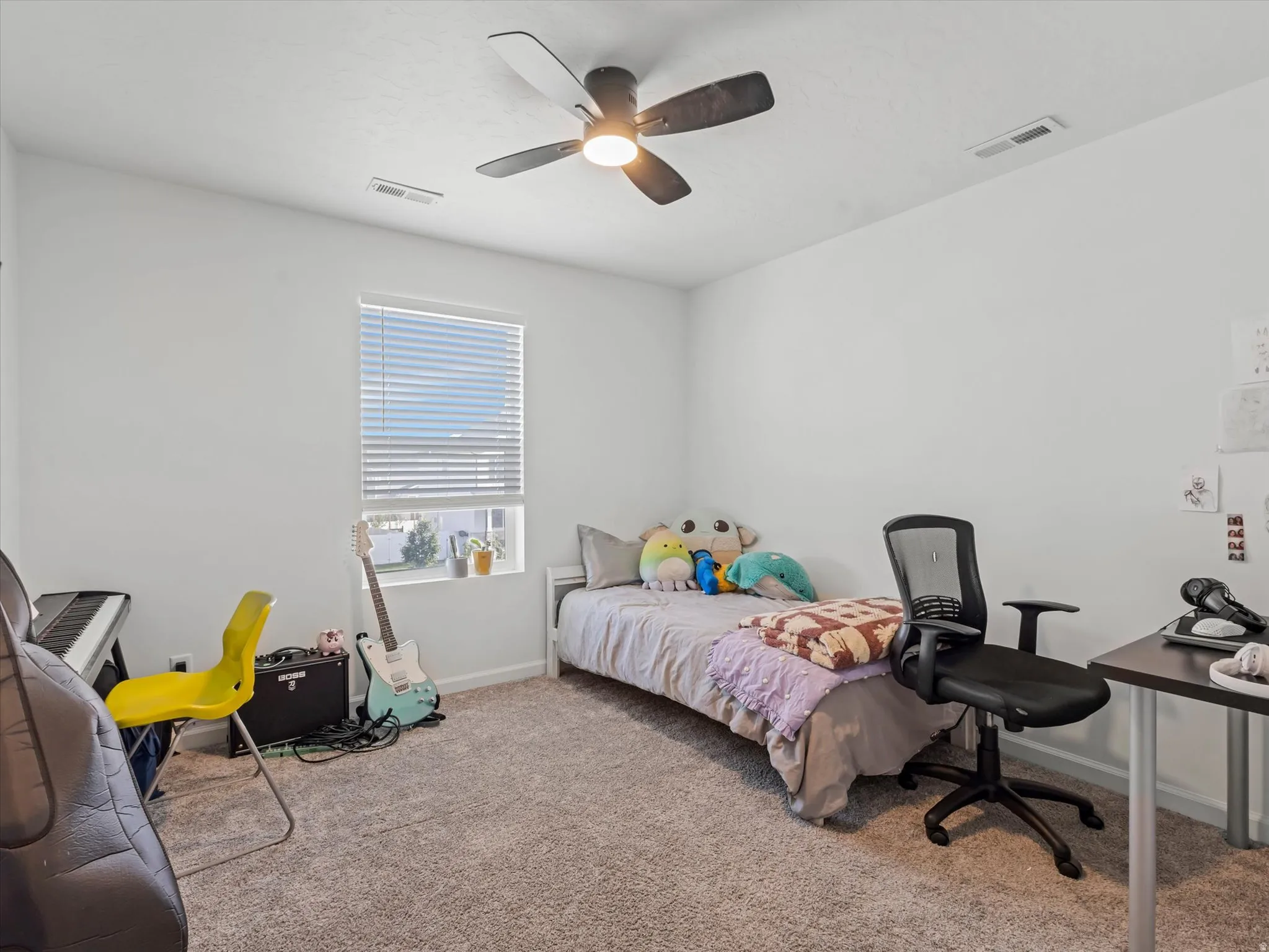 Carpeted room with a ceiling fan, recessed lighting, and a window featuring horizontal blinds