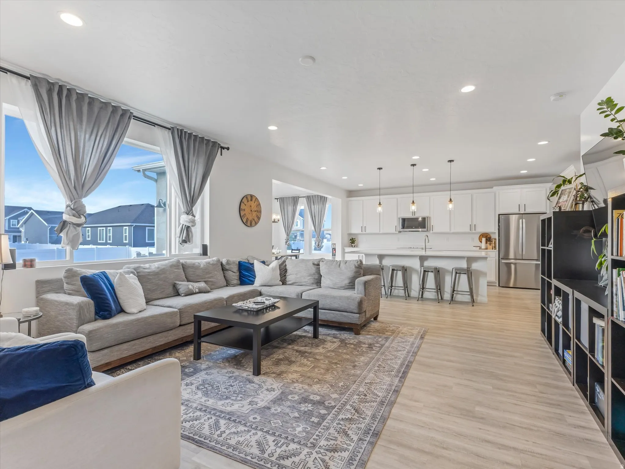 Open-concept living area featuring light wood-finish flooring and recessed lighting