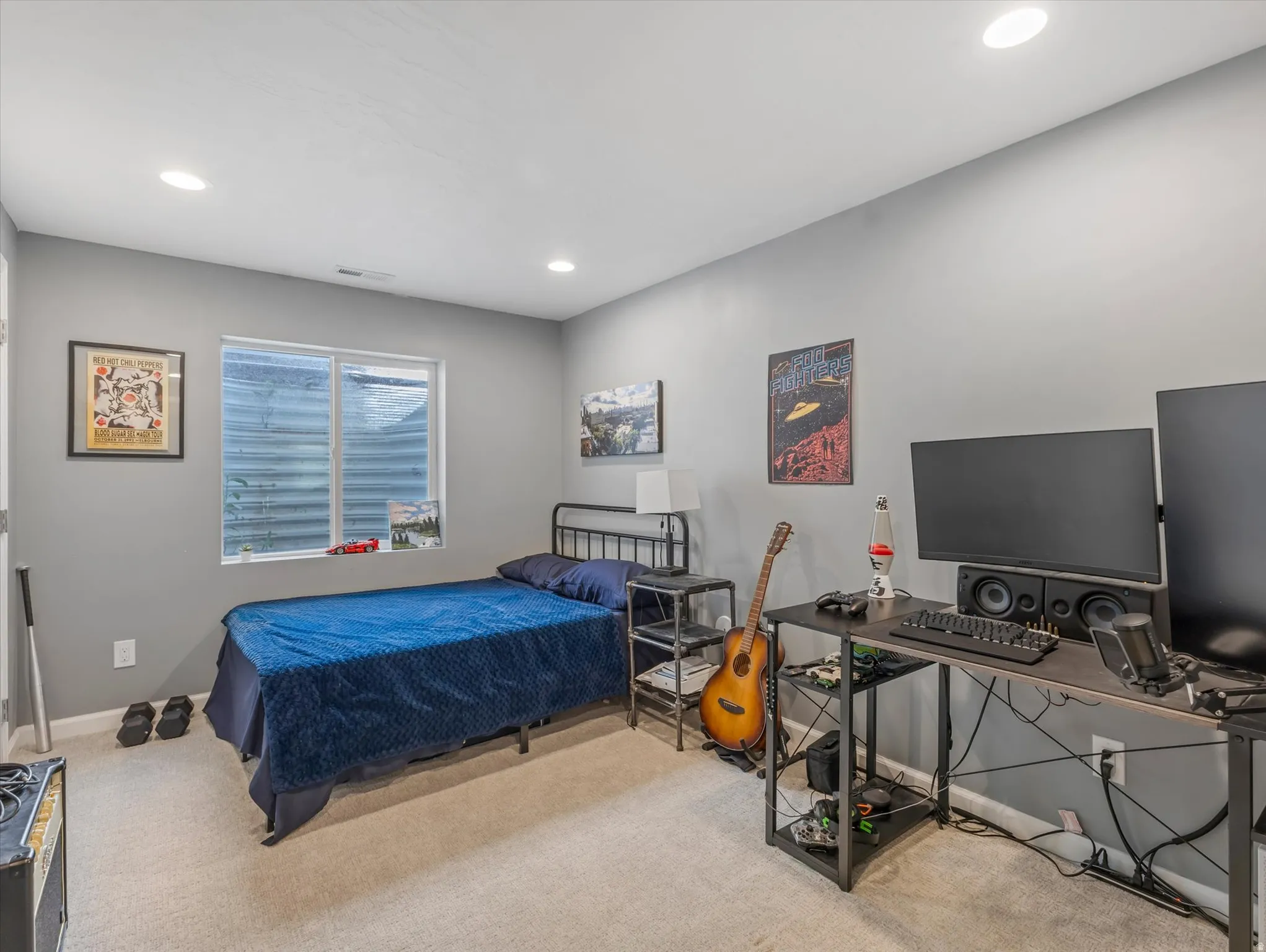 Carpeted room featuring light gray walls, recessed lighting, and a horizontal window with a white frame