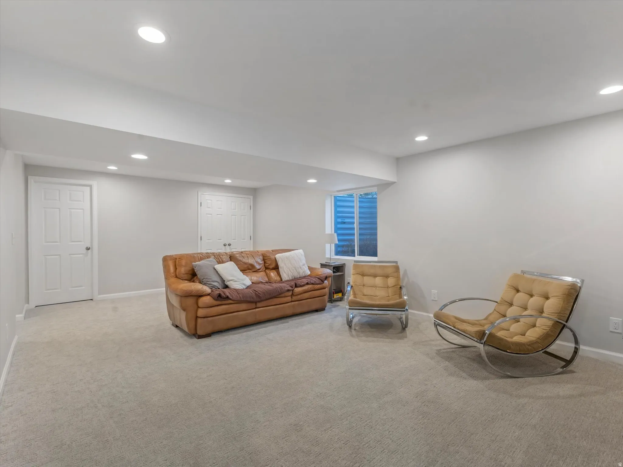 Spacious room with light neutral carpeting and recessed lighting