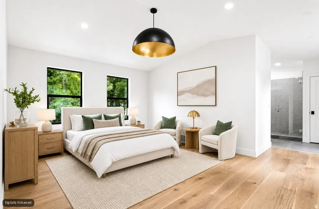 Hardwood-style flooring throughout, vaulted ceiling, recessed lighting, and a modern dome pendant light