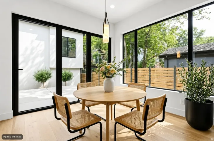 Hardwood-finish flooring with expansive glass paneling and a dedicated outdoor patio