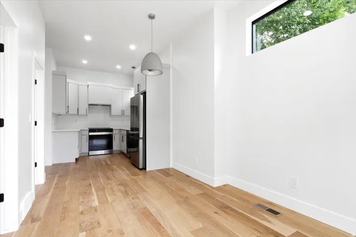 Open-concept living space with light wood-finish flooring