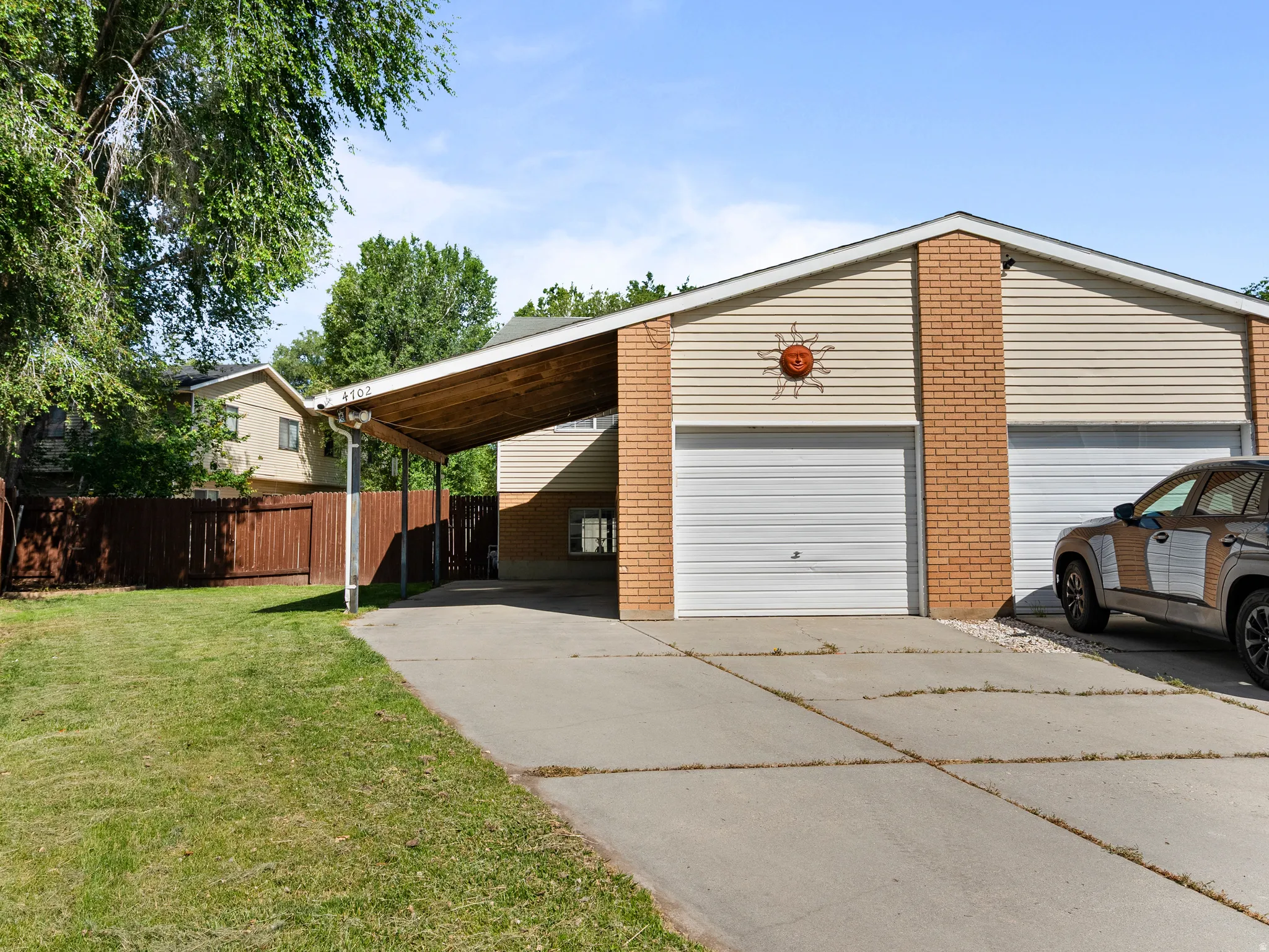 One car garage and covered  carport on left of the twin home.
