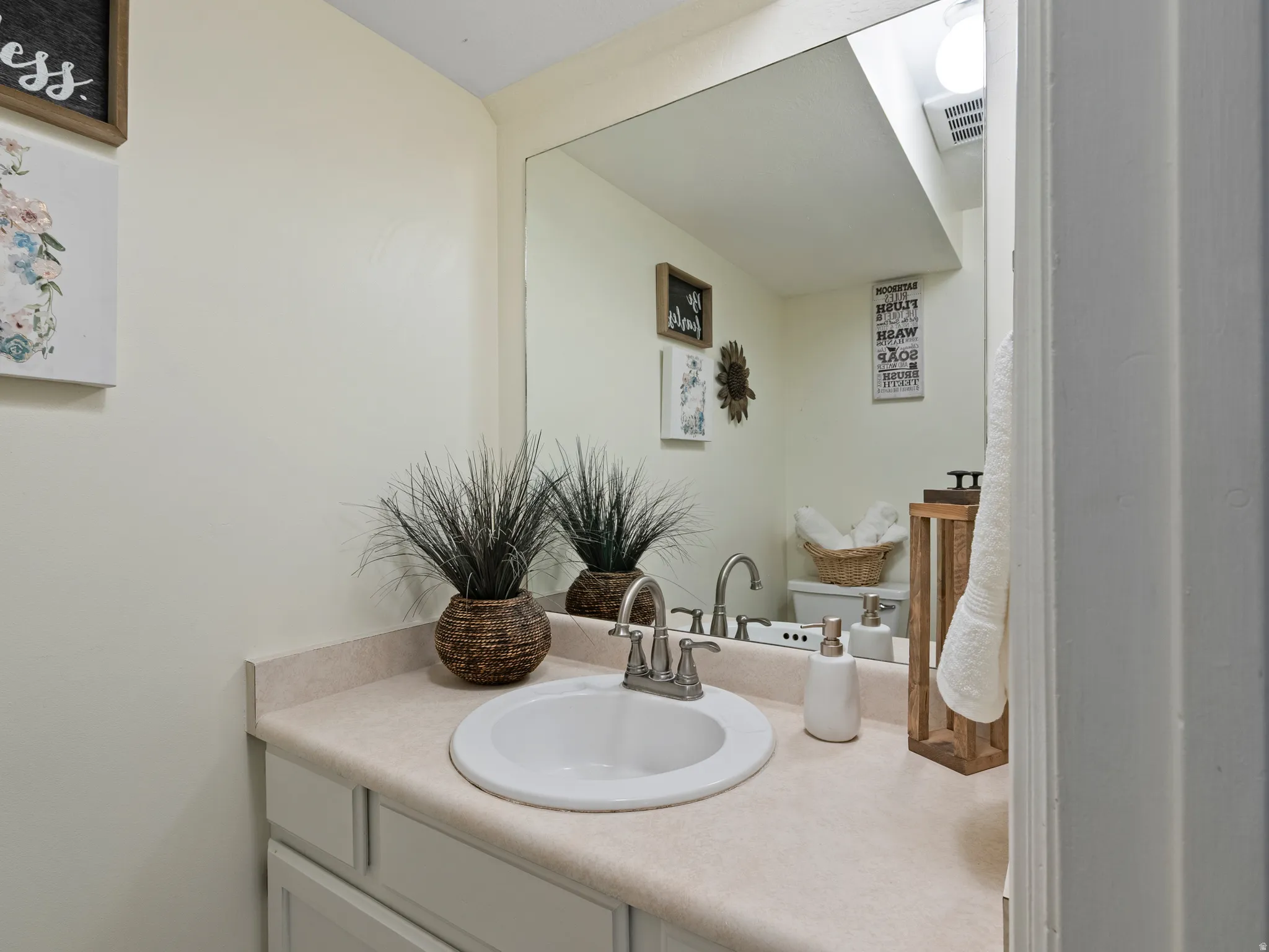 Half bathroom at base of stairs near kitchen