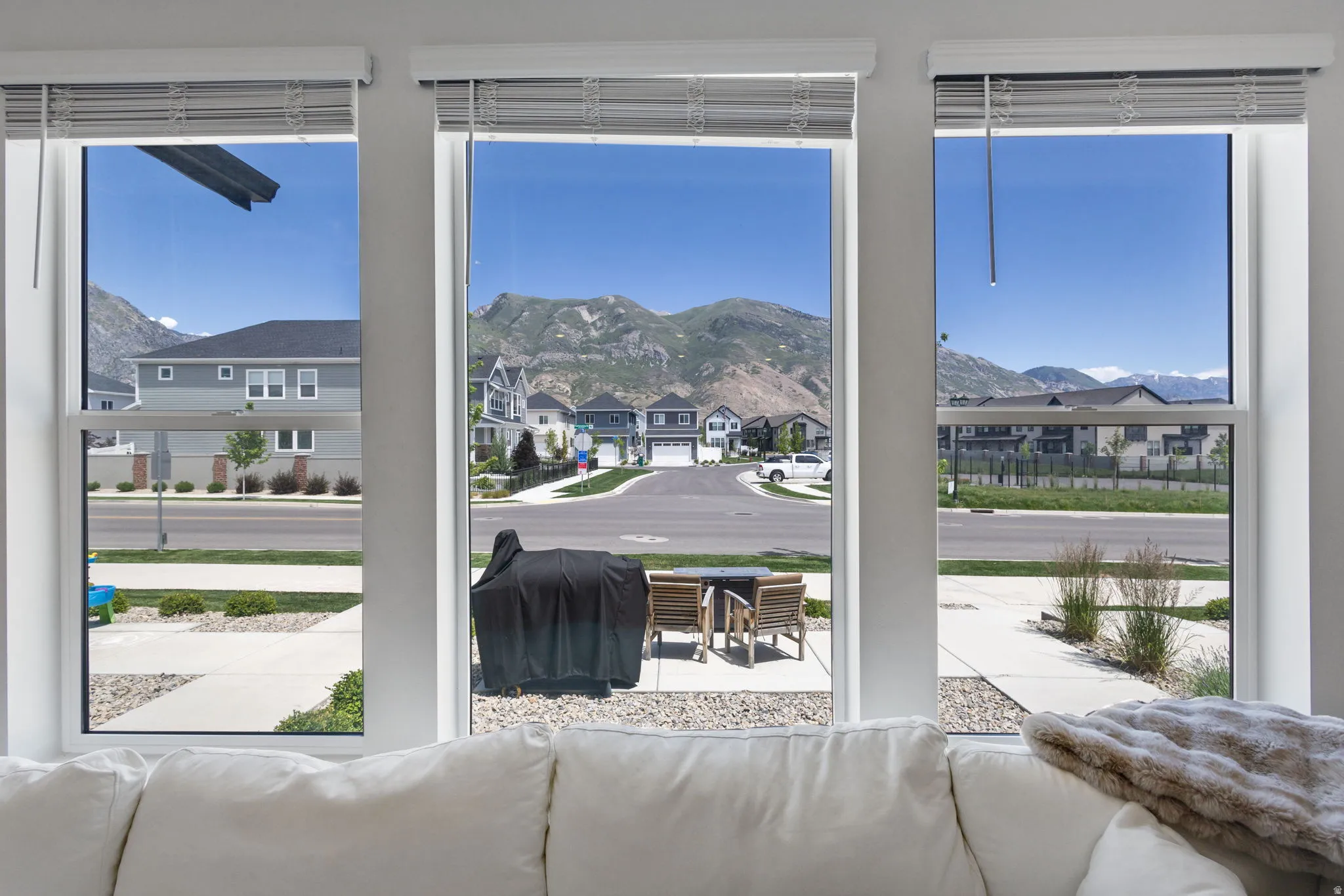 Triple window arrangement featuring white blinds and clear glass panes