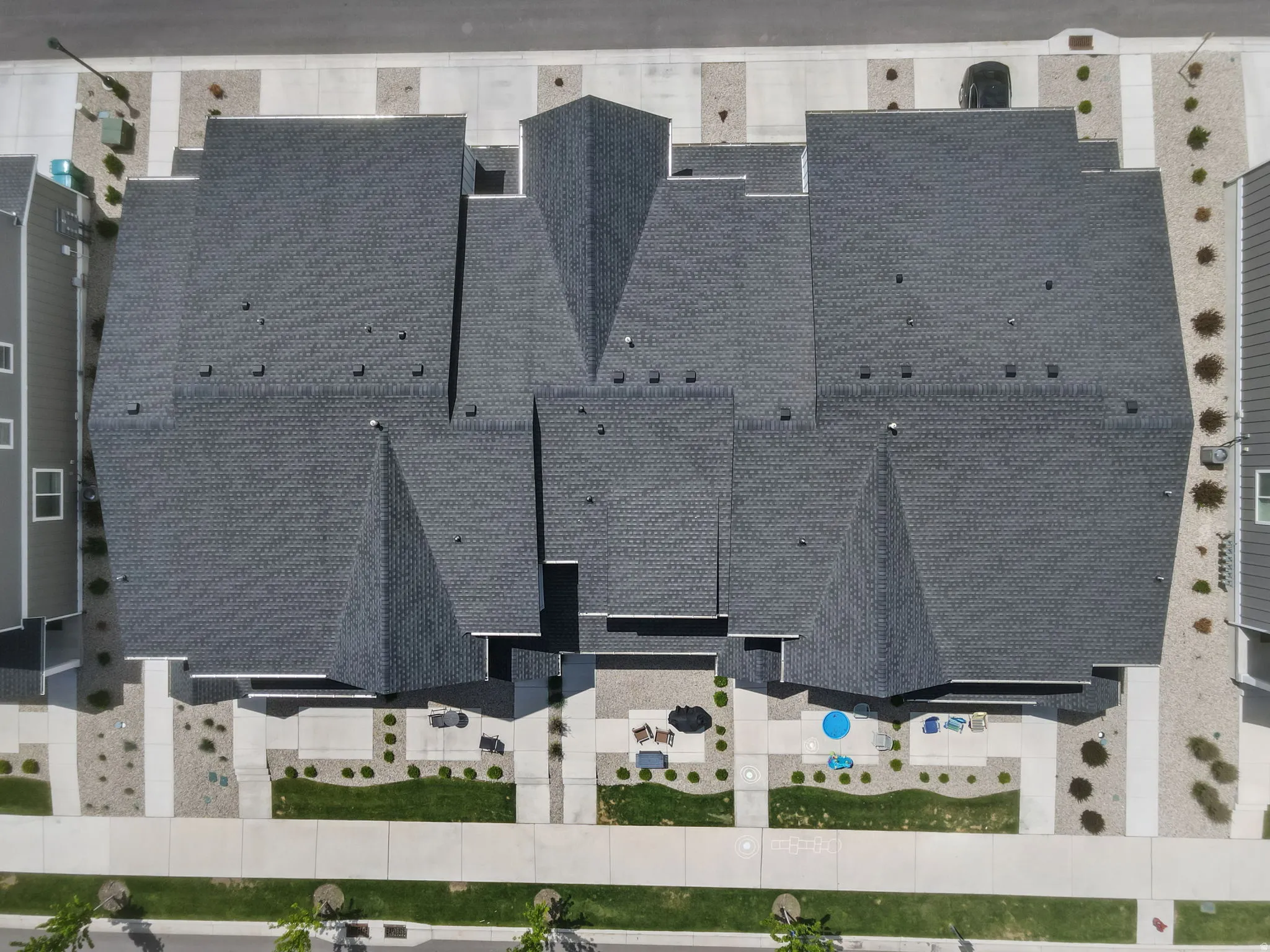 Aerial perspective showcasing multiple residential structures with dark shingle roofing