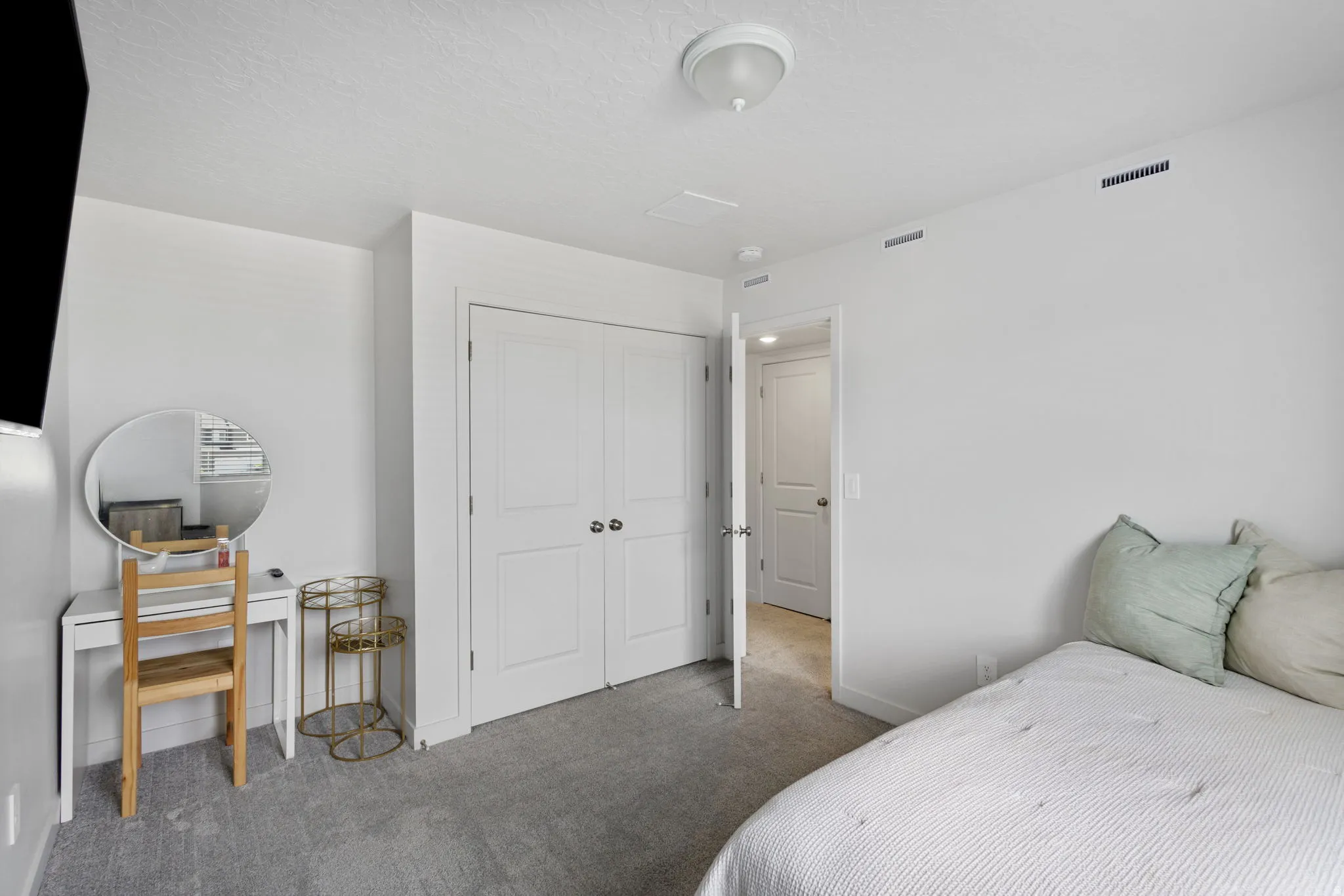 Bedroom with neutral carpeting and white walls