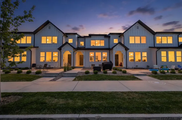Contemporary townhome exterior with white siding and dark trim accents
