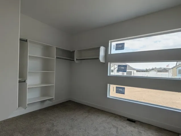 Built-in shelving and hanging rods offer versatile storage