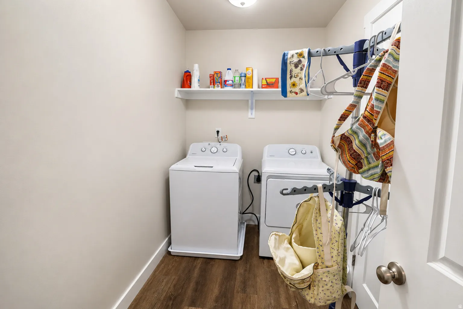 Dedicated laundry area featuring a top-load washer and front-load dryer
