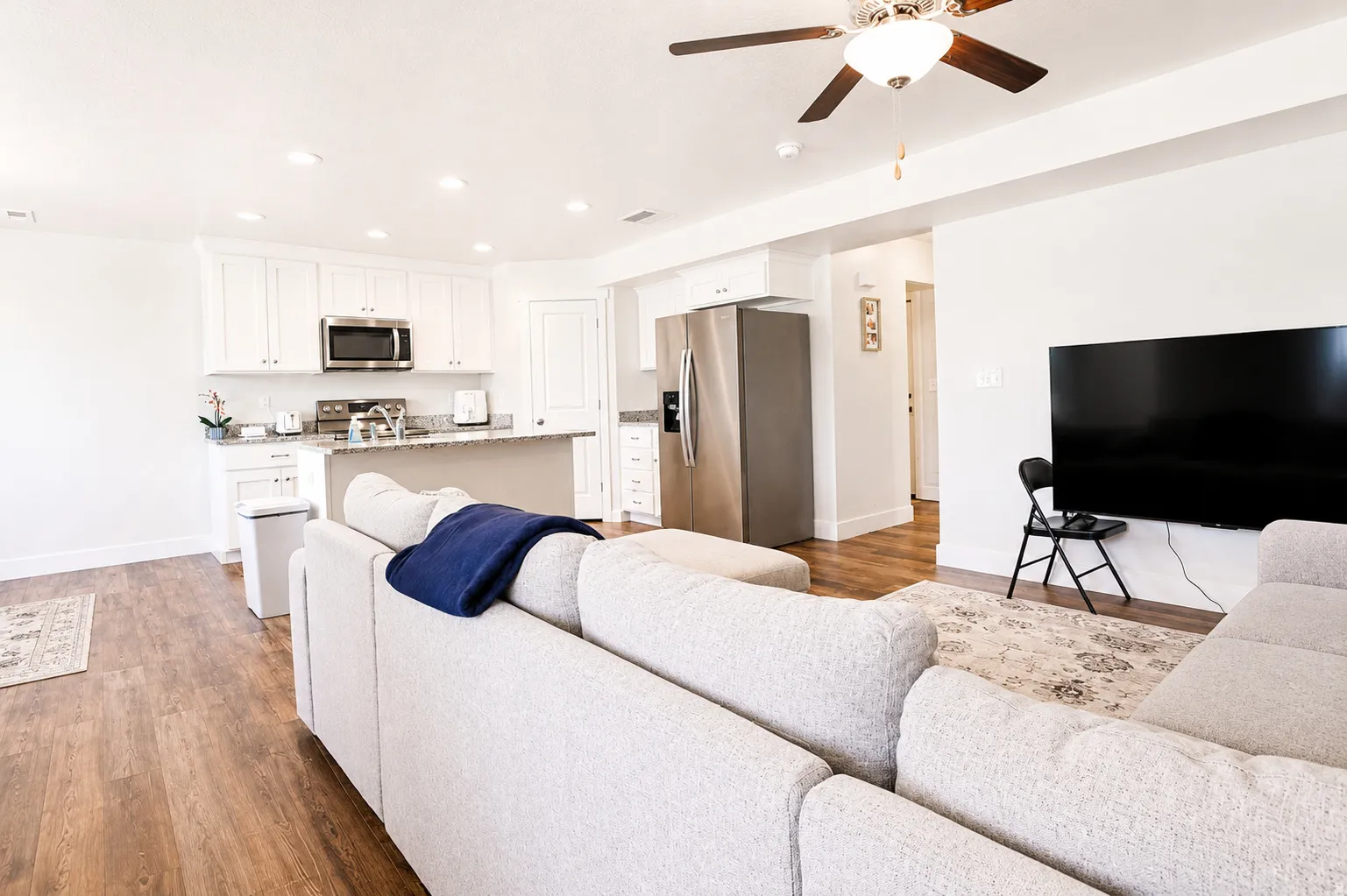 Open-concept living space with wood-finish flooring