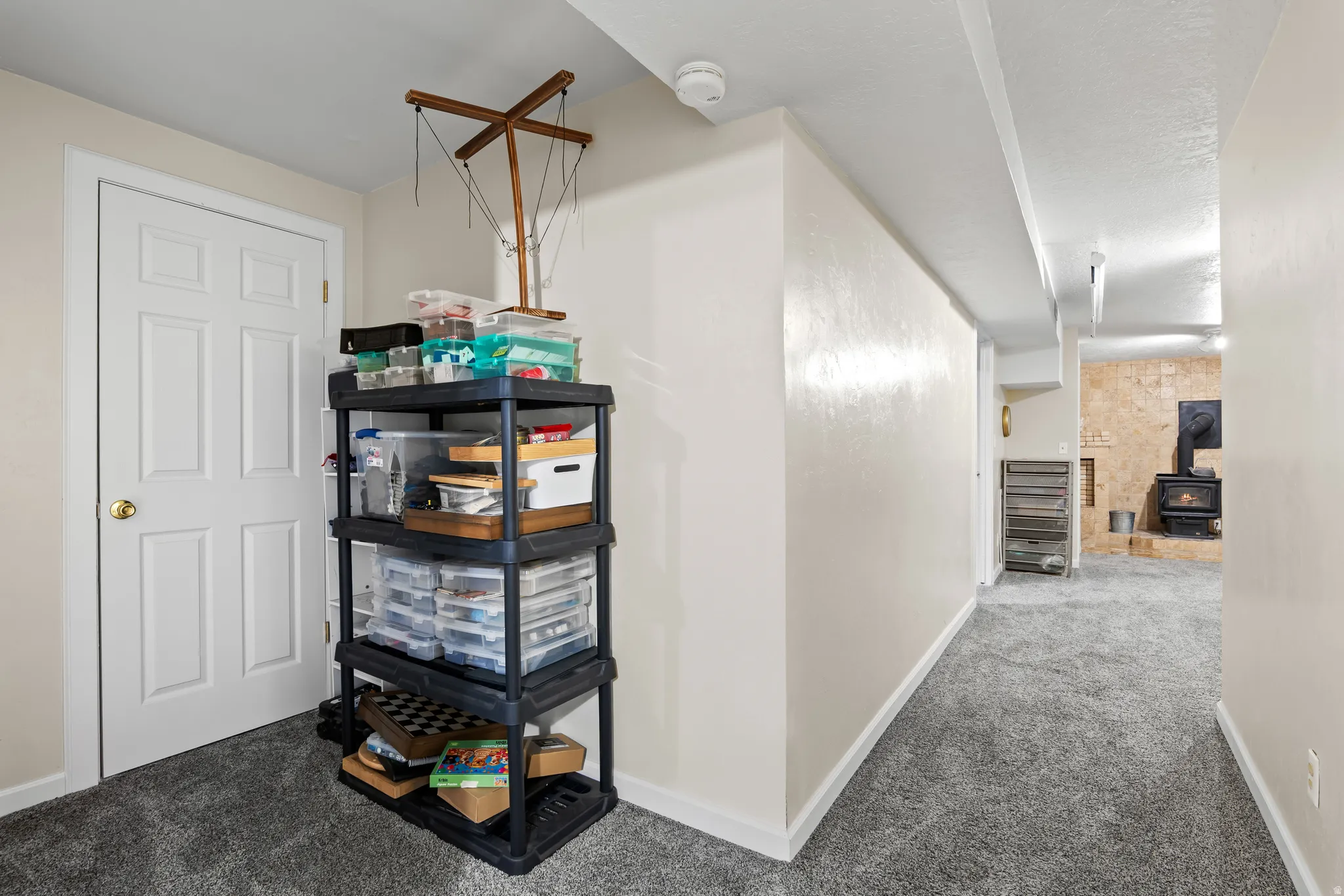Carpeted hallway with light-colored walls and white trim