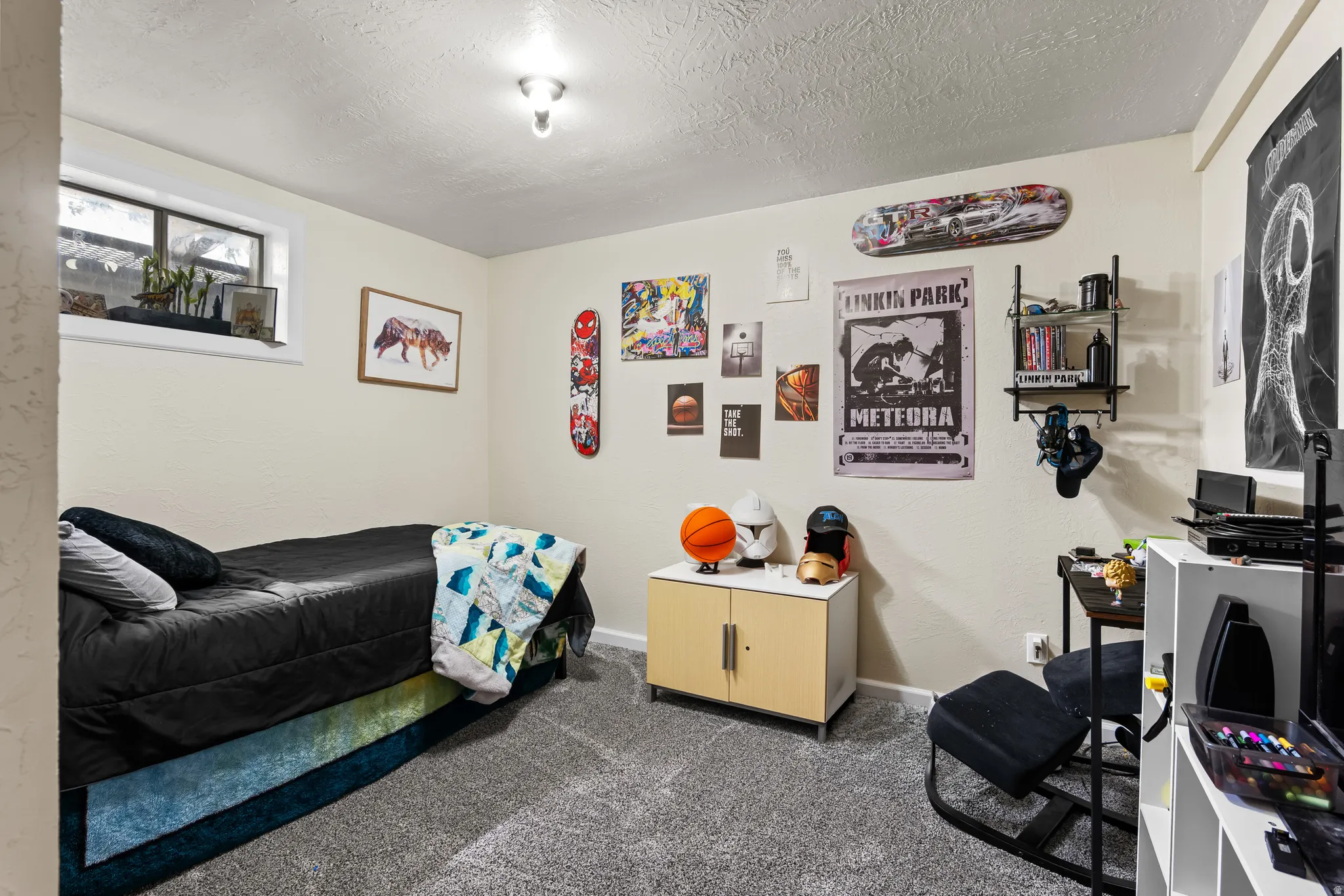 Carpeted room with a single window and recessed lighting