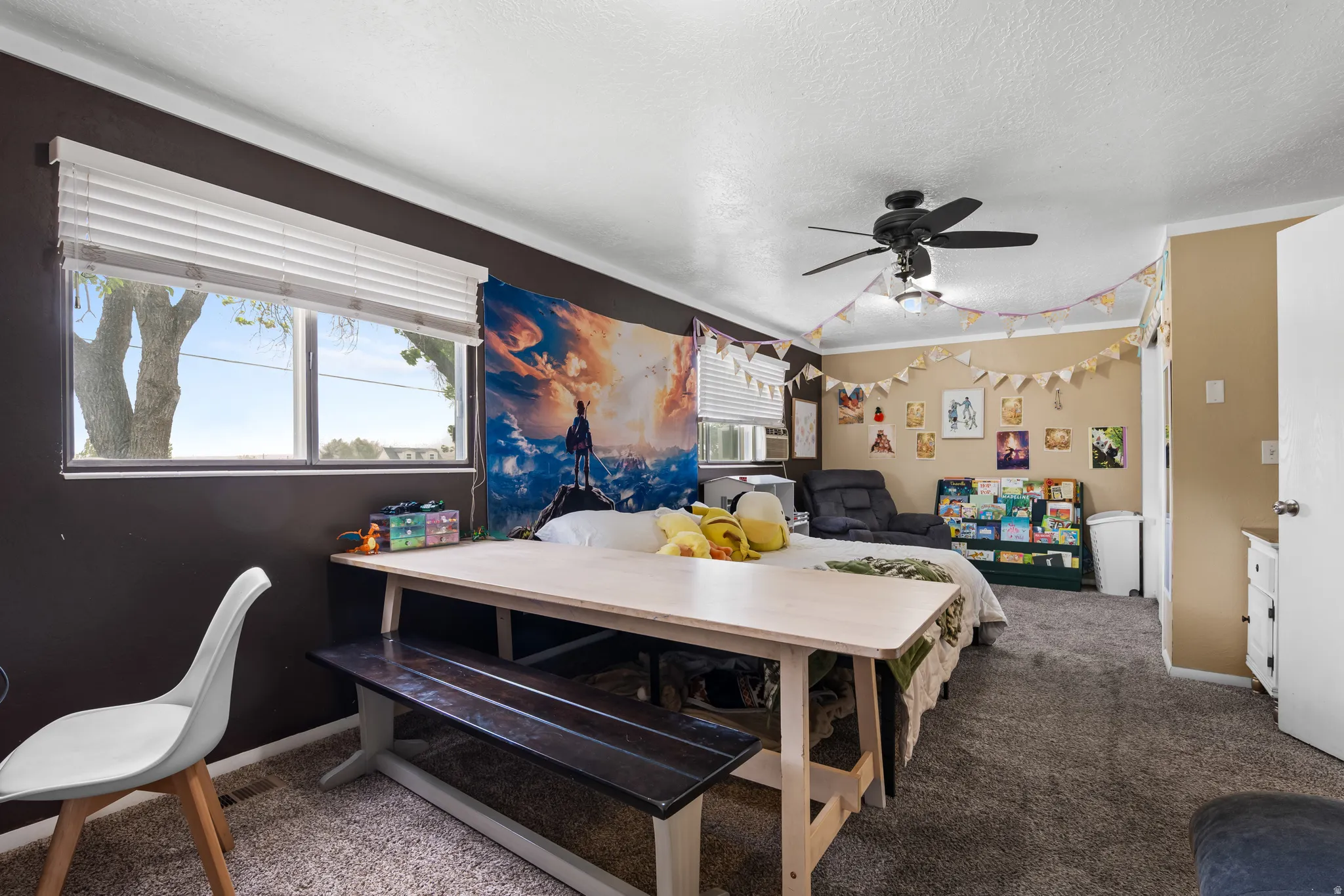 Spacious room featuring neutral carpeting, a dual-pane window with horizontal blinds, and a ceiling fan with integrated lighting