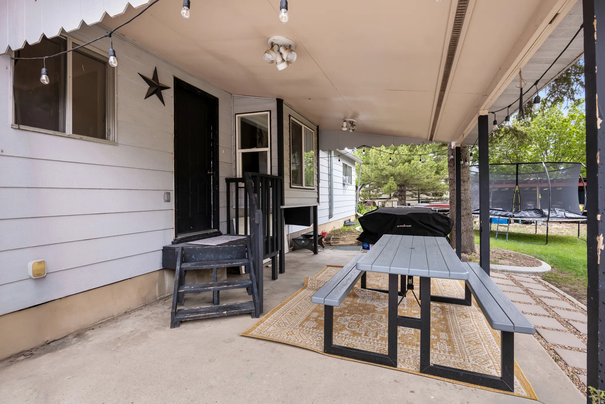 Covered concrete patio with shiplap siding exterior