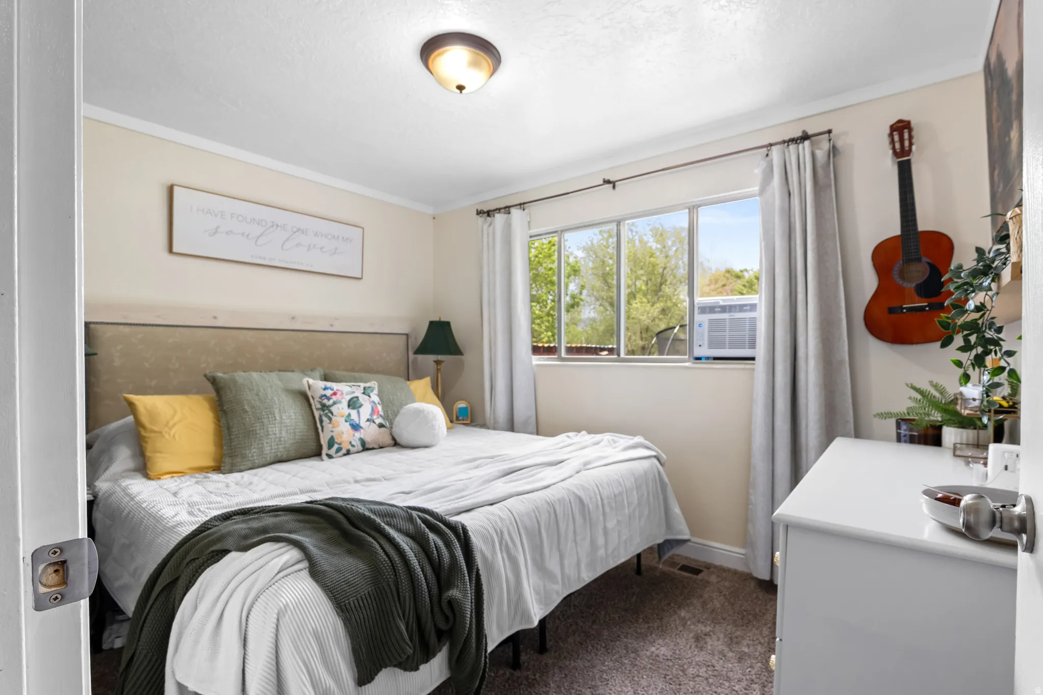 Bedroom featuring neutral wall paint, carpet flooring, a multi-pane window, and a flush mount ceiling light fixture
