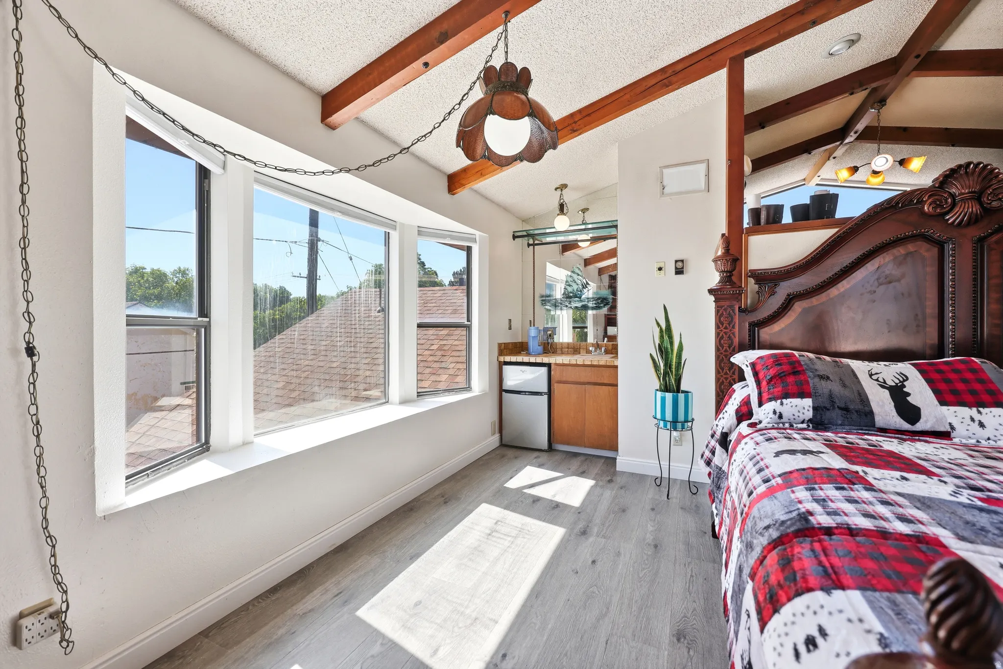 Light wood-finish flooring complements exposed ceiling beams