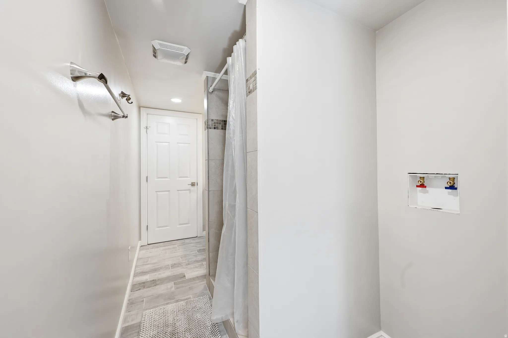 Bathroom featuring a shower with tiled walls and a textured floor
