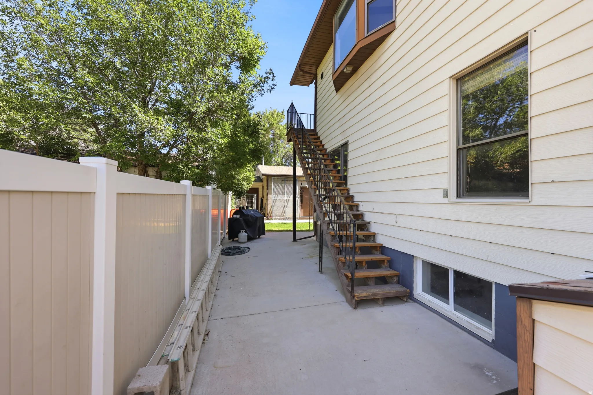 Exterior side patio featuring a concrete surface
