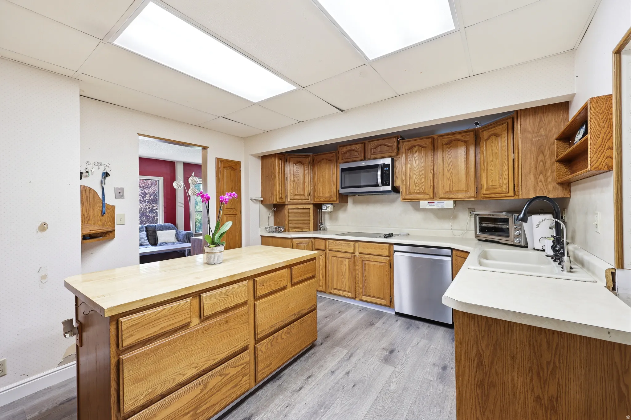 Kitchen featuring a central island with wood cabinetry, wood-finish flooring, and recessed ceiling lighting