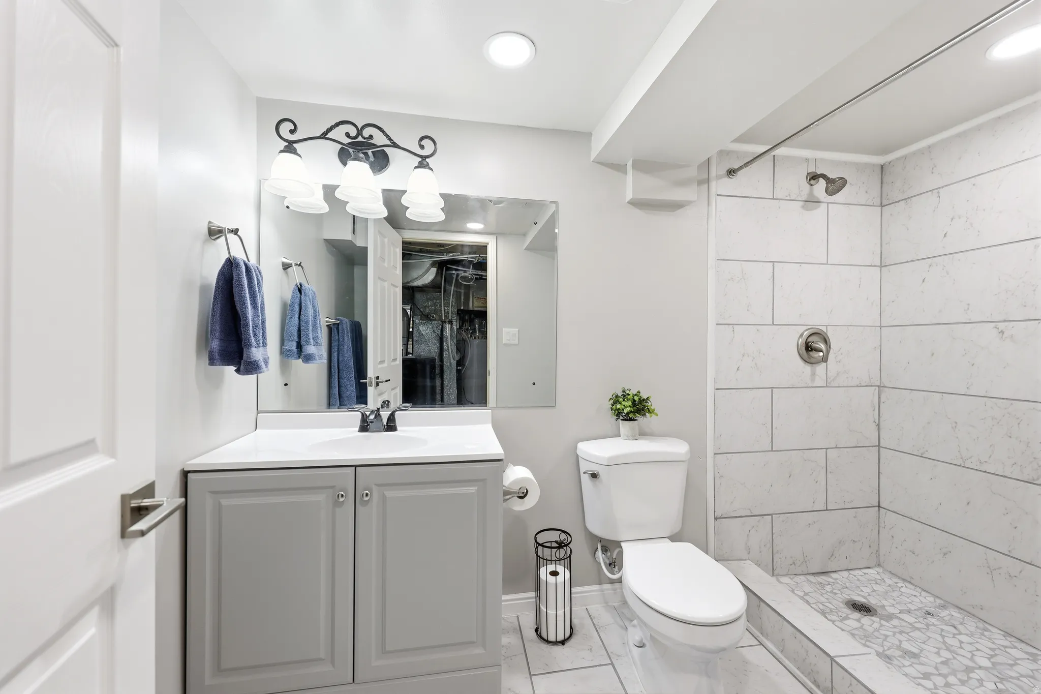 Bathroom featuring a gray vanity with a white countertop and integrated sink