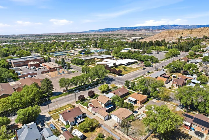 Expansive aerial perspective showcasing a residential neighborhood with mature trees and diverse architectural styles