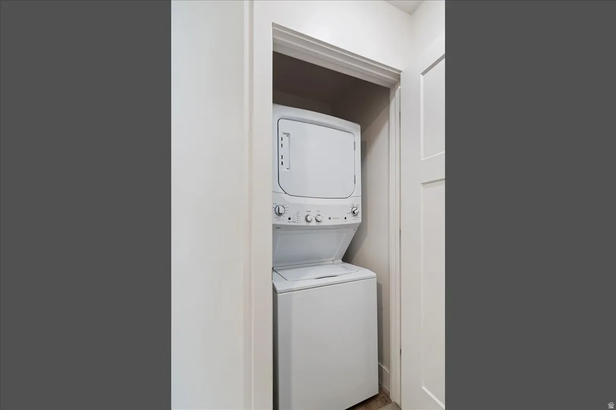 Dedicated laundry closet with a stacked washer and dryer
