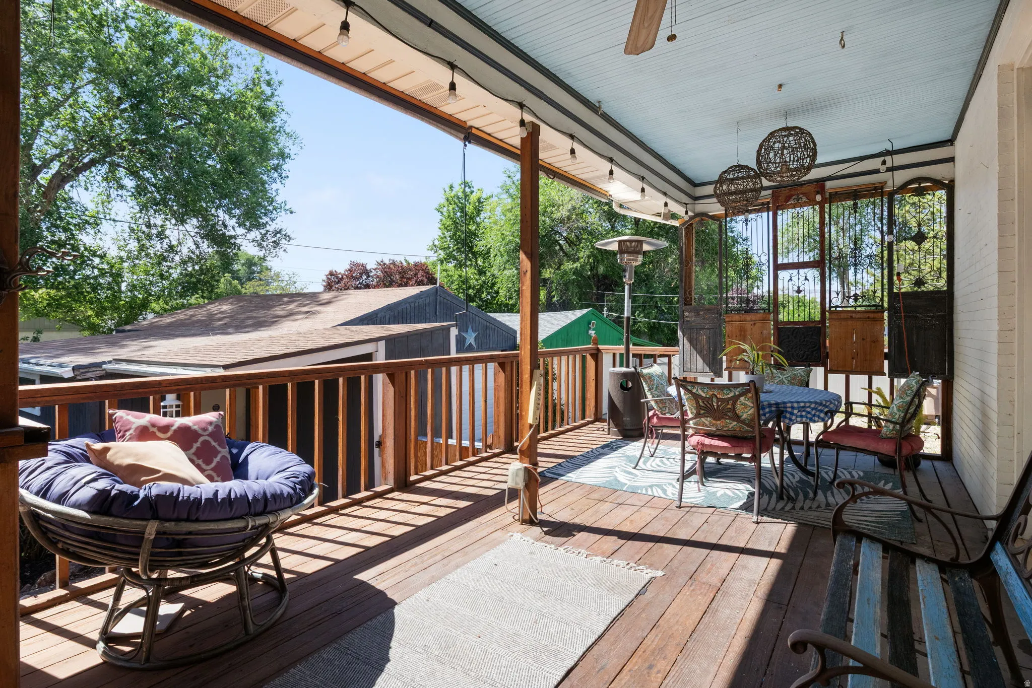 Covered outdoor deck with wood-finish flooring and railing