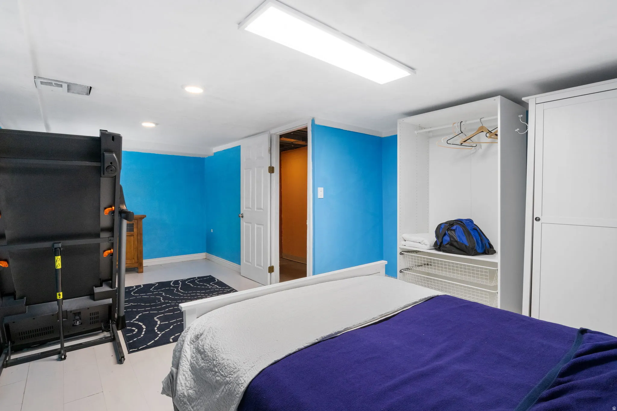 Room with light-colored flooring and a white ceiling featuring recessed lighting and a large overhead flush-mount light fixture