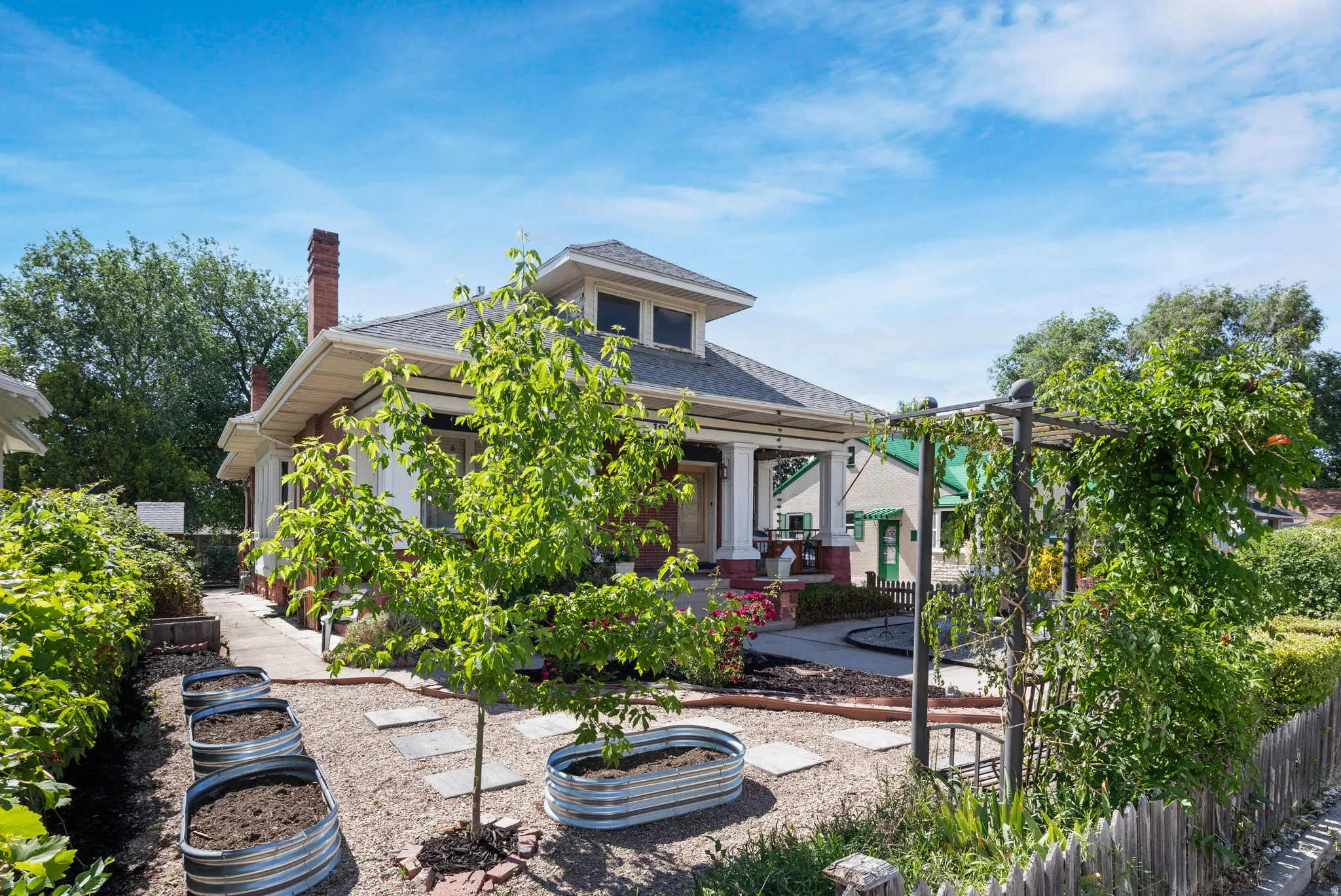 Craftsman-style exterior with a covered front porch and brick chimney