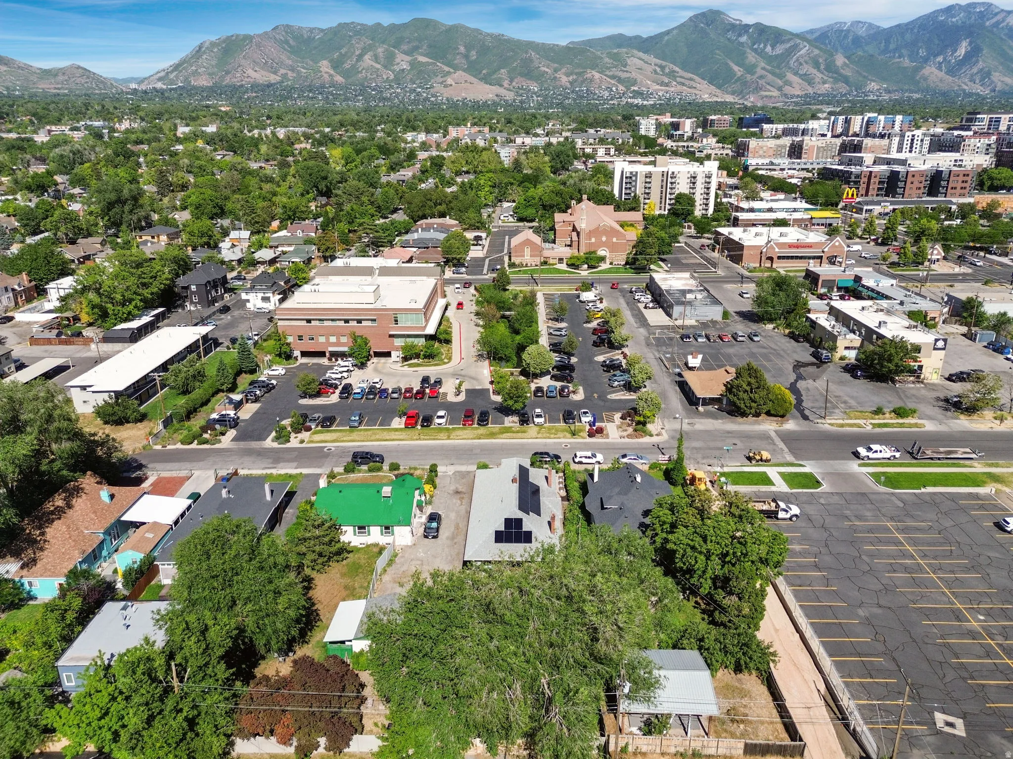 Expansive aerial perspective showcasing the surrounding urban landscape with distant mountains