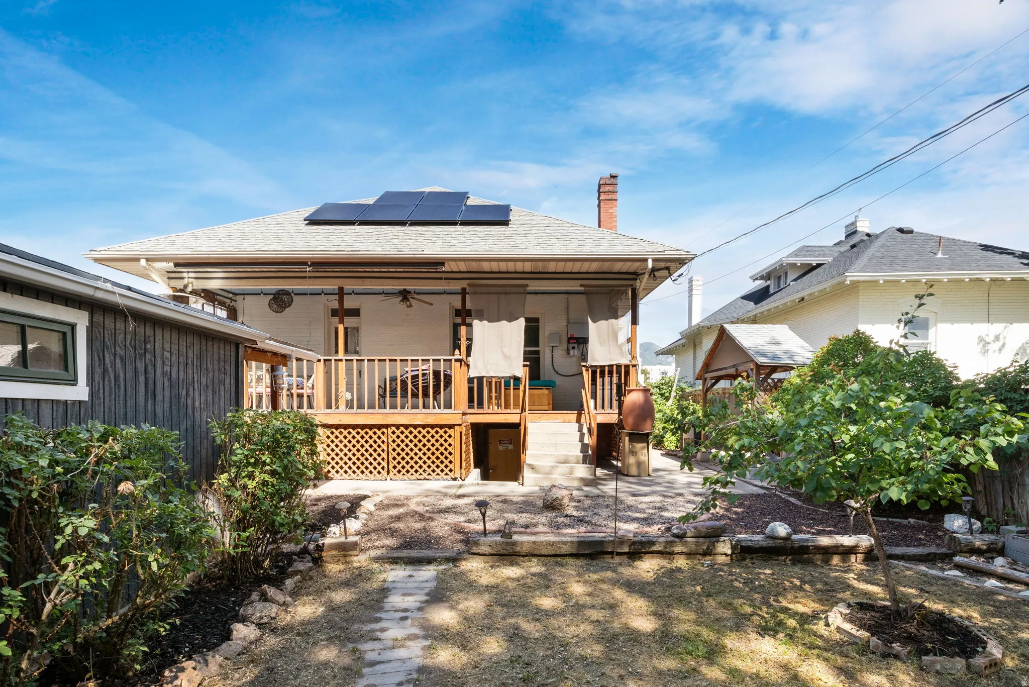 Backyard featuring a covered wood deck with lattice detailing
