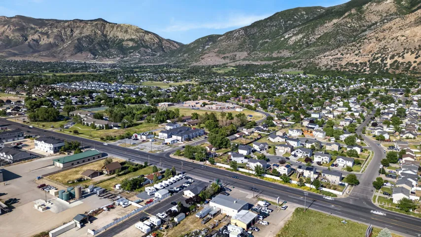 Expansive aerial perspective showcasing a residential neighborhood with mountain backdrops