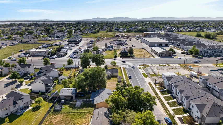 Aerial perspective showcasing a mixed-use area with residential structures and commercial buildings