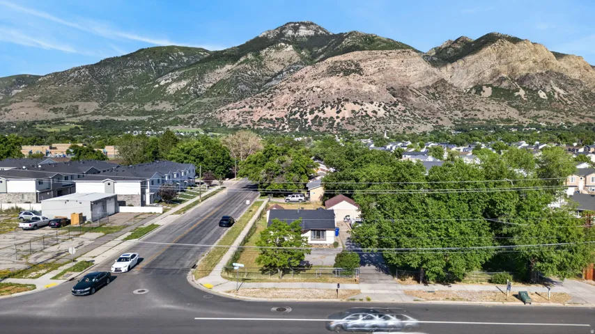Mountainous backdrop with established residential areas and mature trees