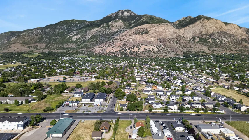 Expansive mountain range backdrop framing a residential area with varied housing styles