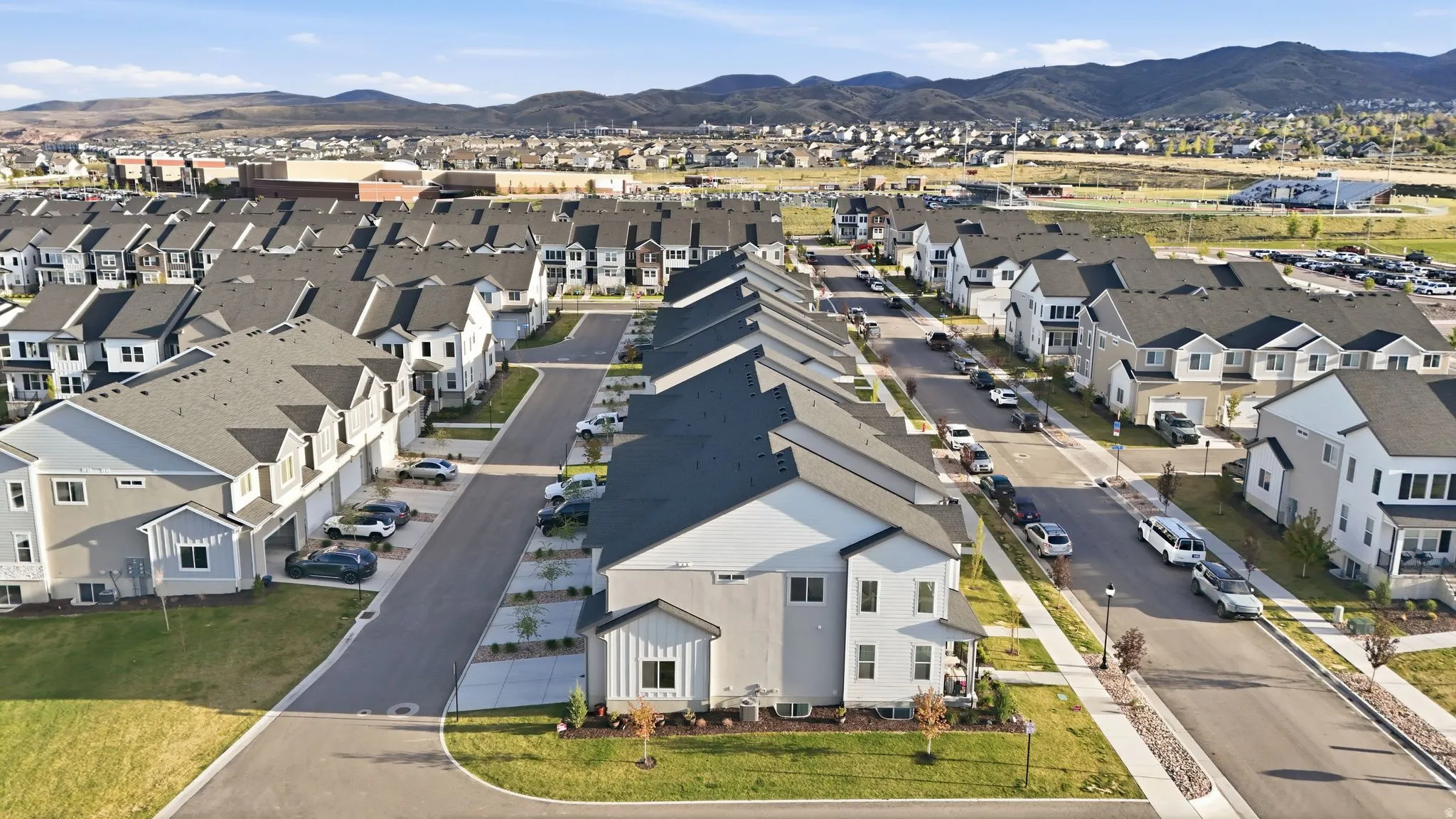Contemporary residential community featuring uniform architectural styles and mountain backdrops