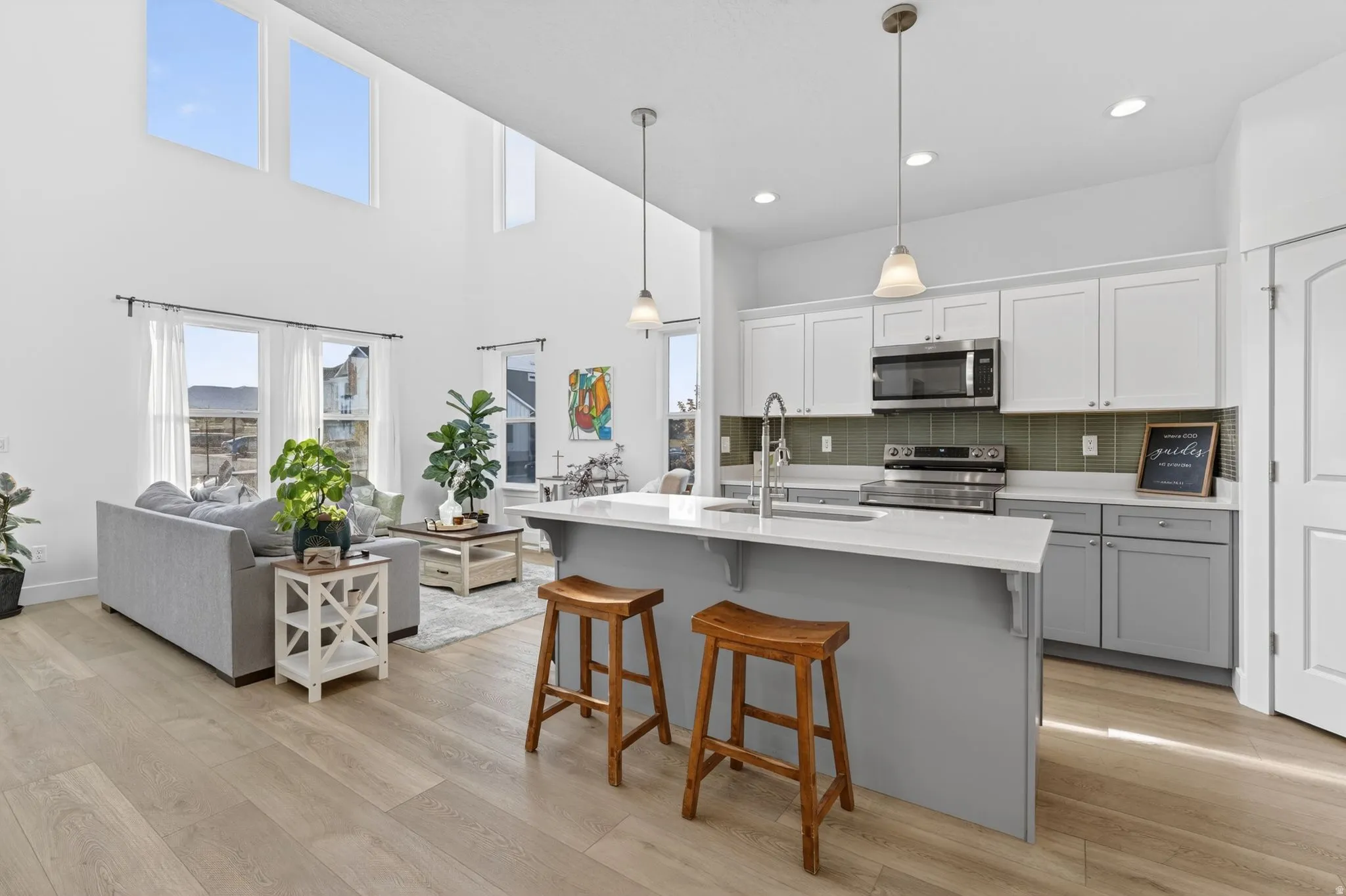 Open-concept living space with wood-finish flooring extending into the kitchen