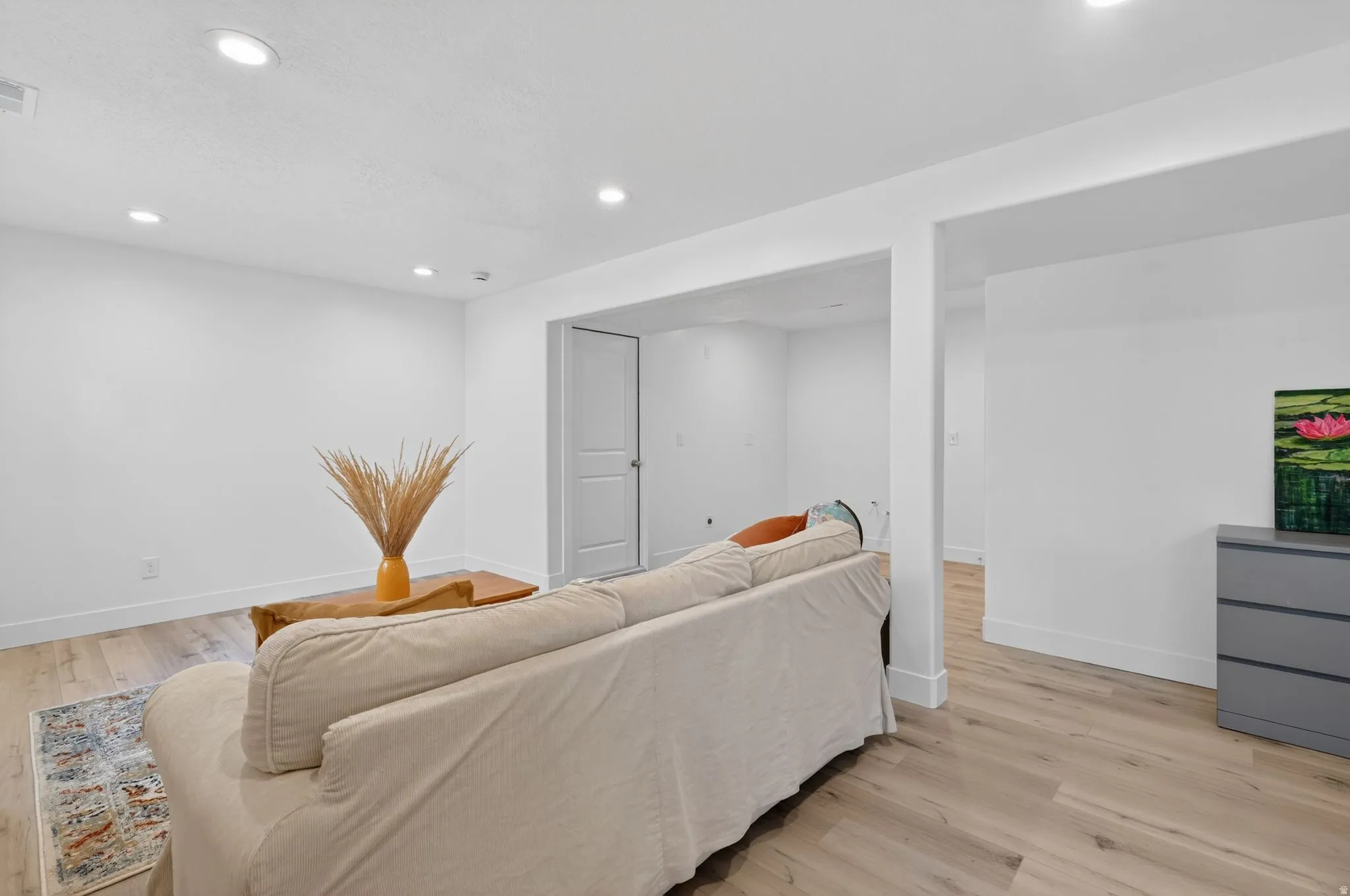 Bright interior space featuring light wood-finish flooring, recessed lighting, and white baseboards