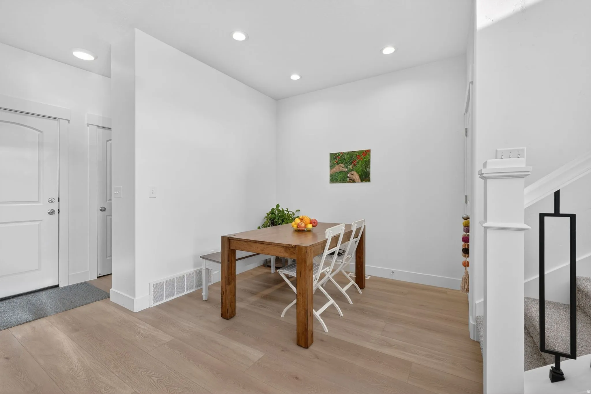 Light wood-finish flooring extending from the entryway