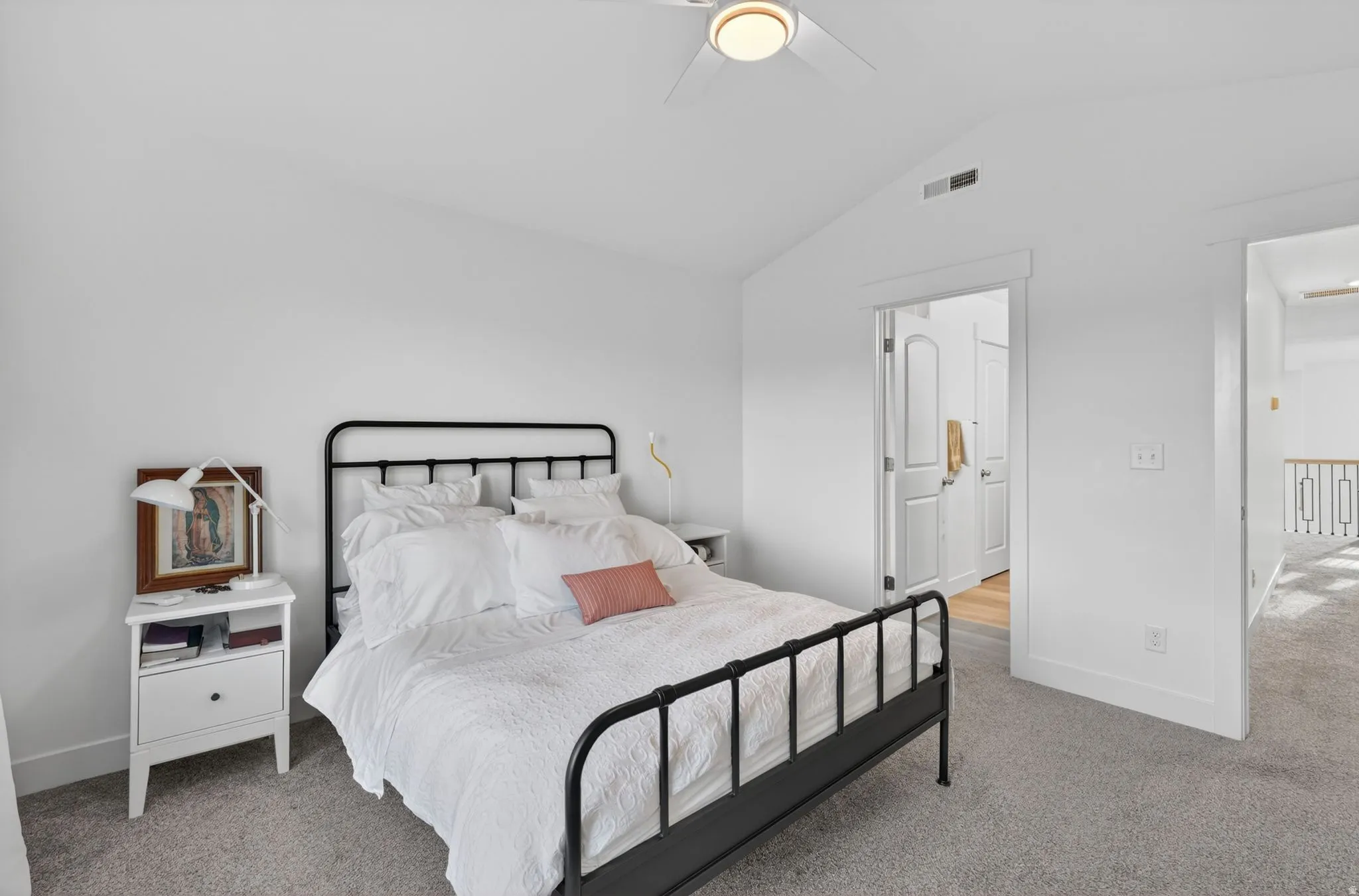 Vaulted ceiling bedroom featuring carpeting and a ceiling fan