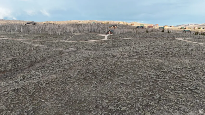 Expansive, undeveloped terrain featuring an unpaved road