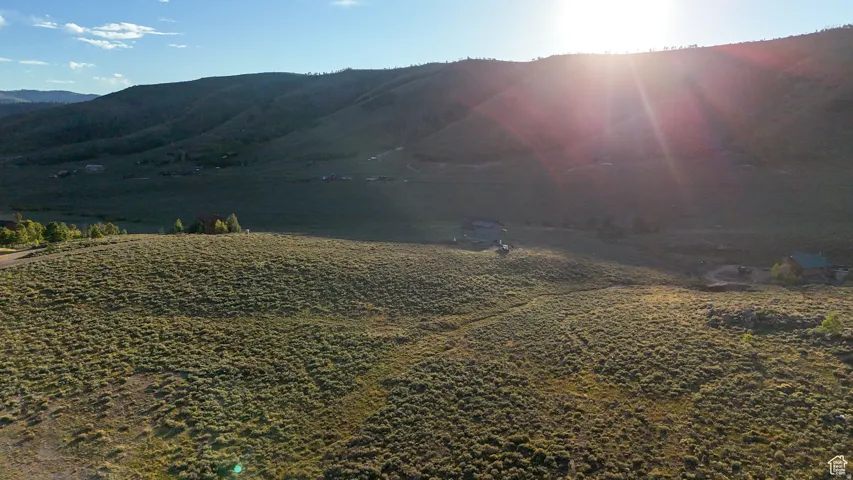 Expansive natural landscape featuring rolling hills and distant mountains