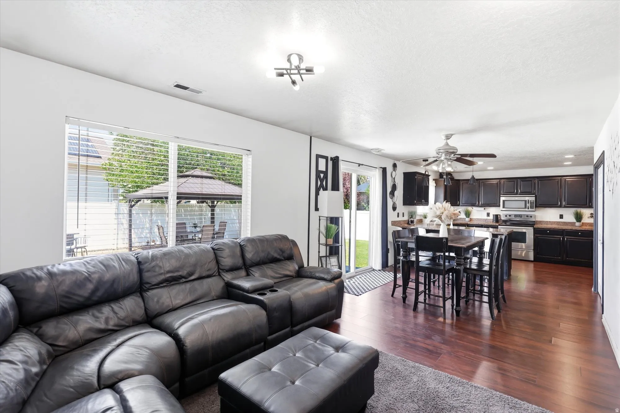 Open-concept living space featuring wood-finish flooring and a bright window