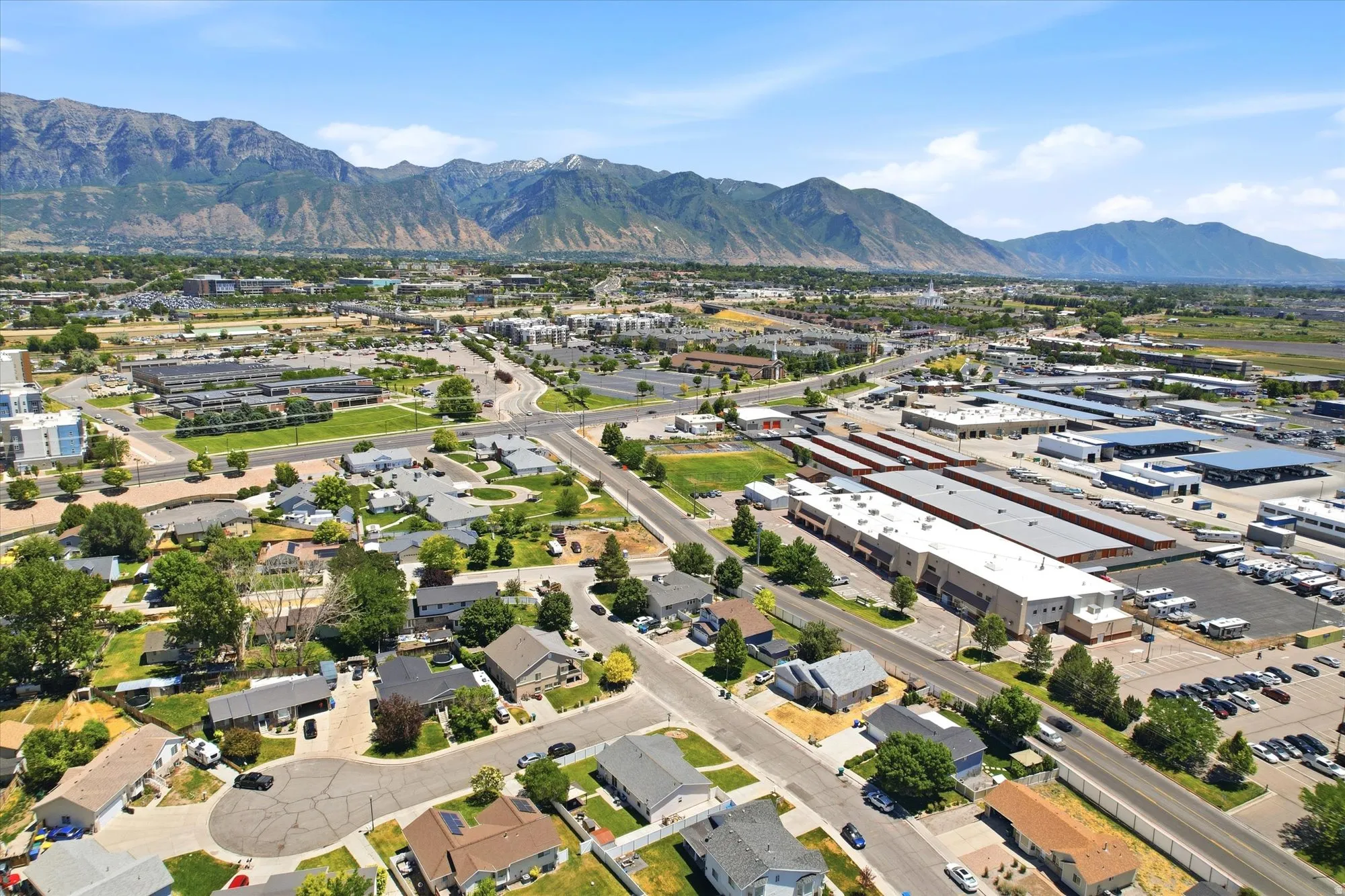 Expansive aerial perspective showcasing a developed community with residential properties and commercial buildings