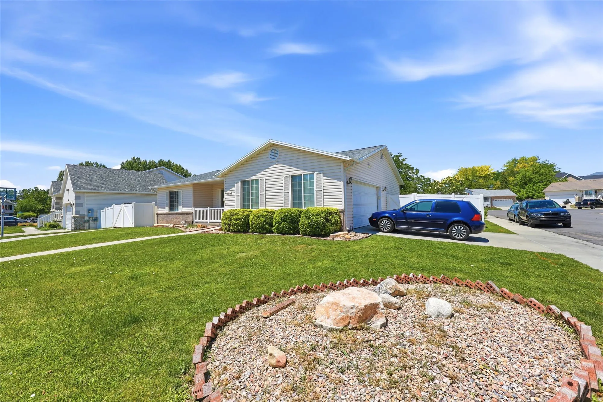 Exterior featuring horizontal siding, a two-car garage, and a front porch with white railings