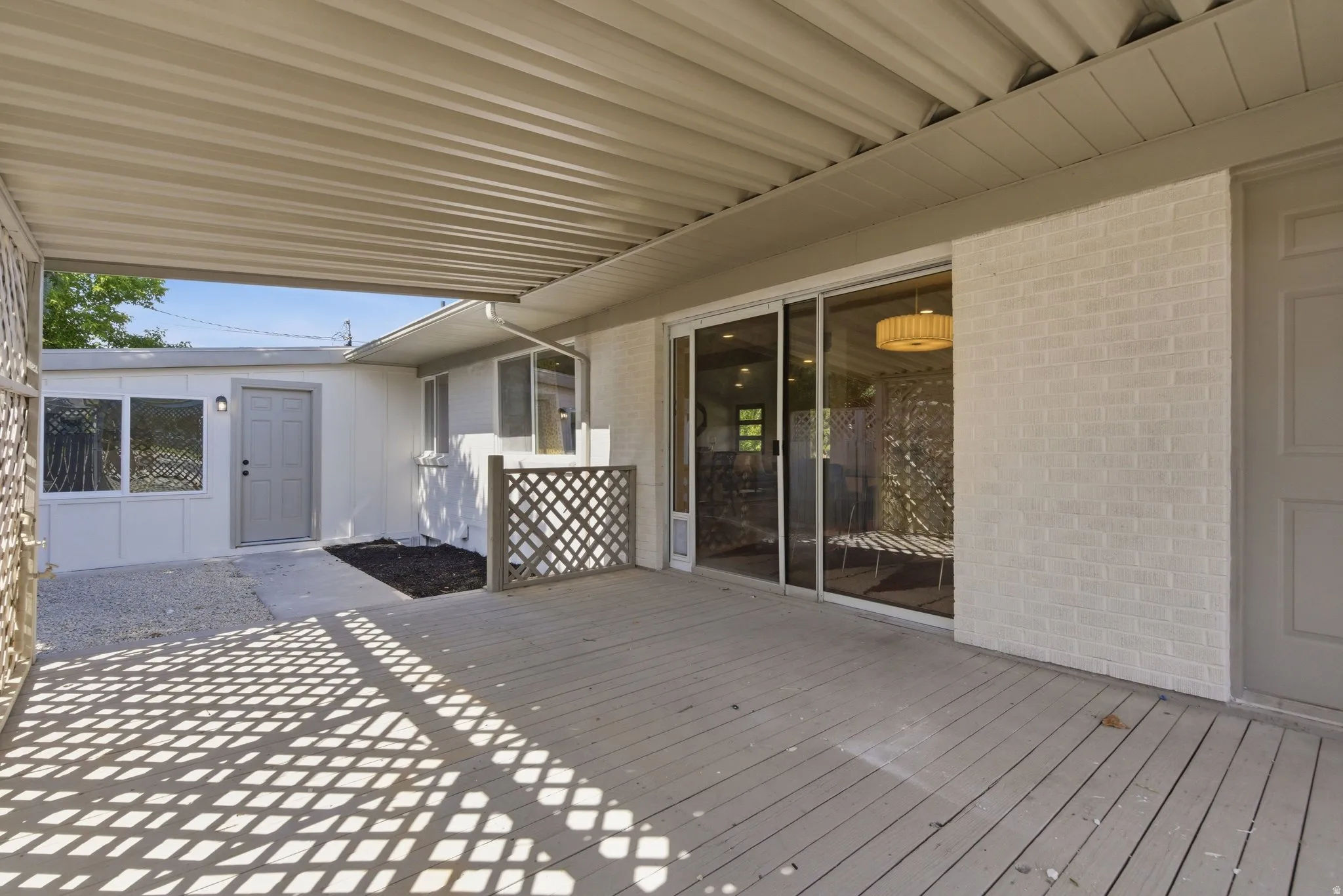 Covered patio featuring a wood-finish deck